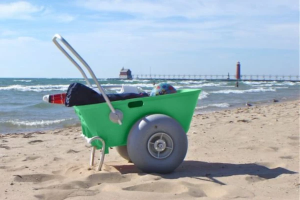 A WheelEEZ Beach Cart loaded with gear and sitting along a beach